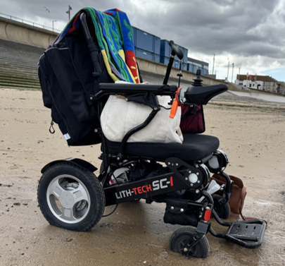 Wheelchair sinking into the sand.